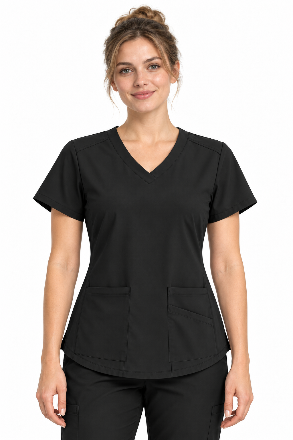 A woman modeling a black V-neck scrub top with short sleeves and two front patch pockets, paired with black scrub pants, against a plain white background.