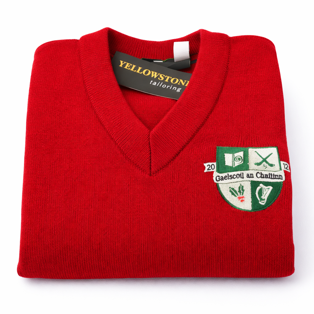 Folded red sweater with a logo and 'Yellowstone Tailoring' tag on a white background