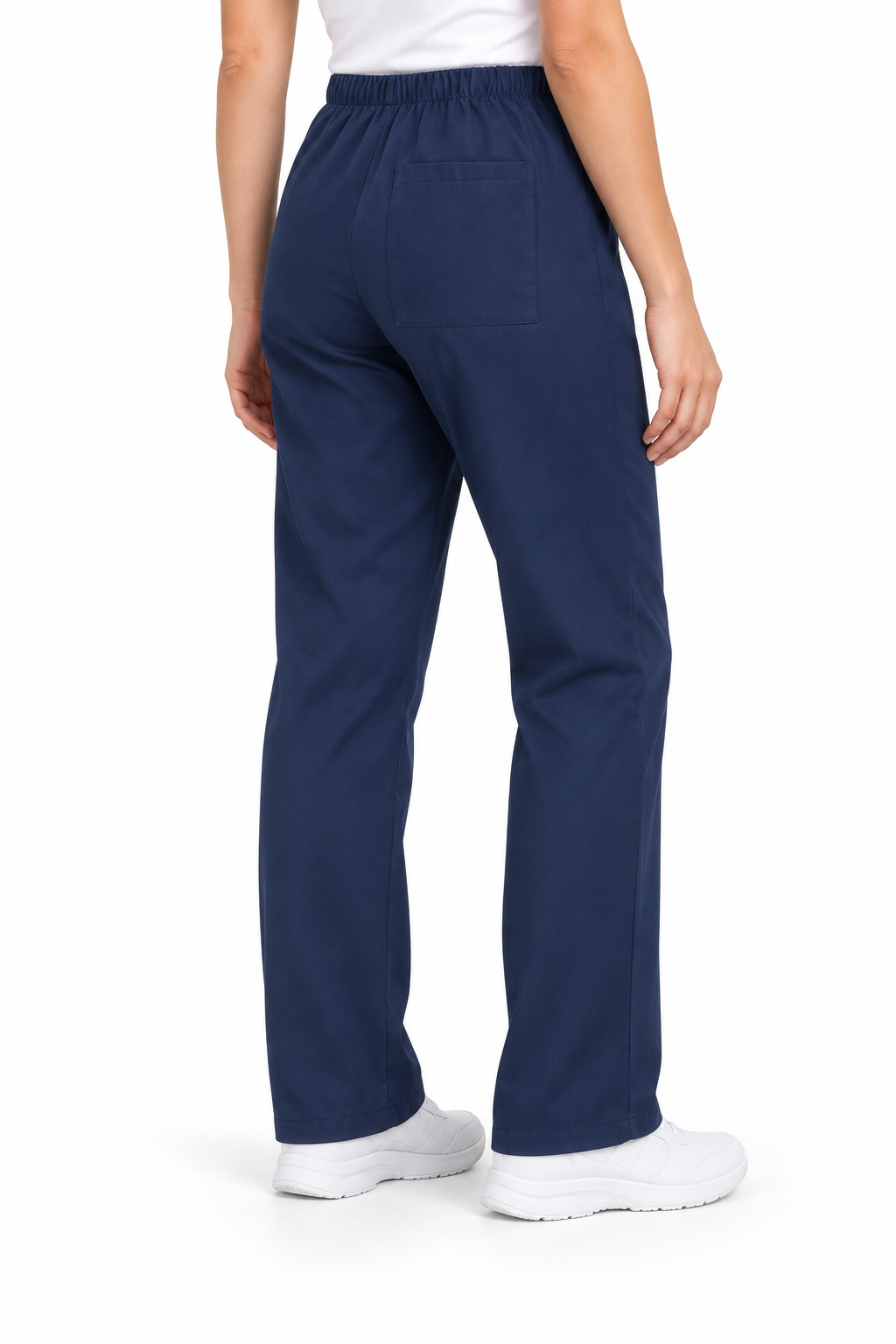 A person shown from the back wearing navy blue scrub pants, a white top, and white sneakers against a plain white studio background.