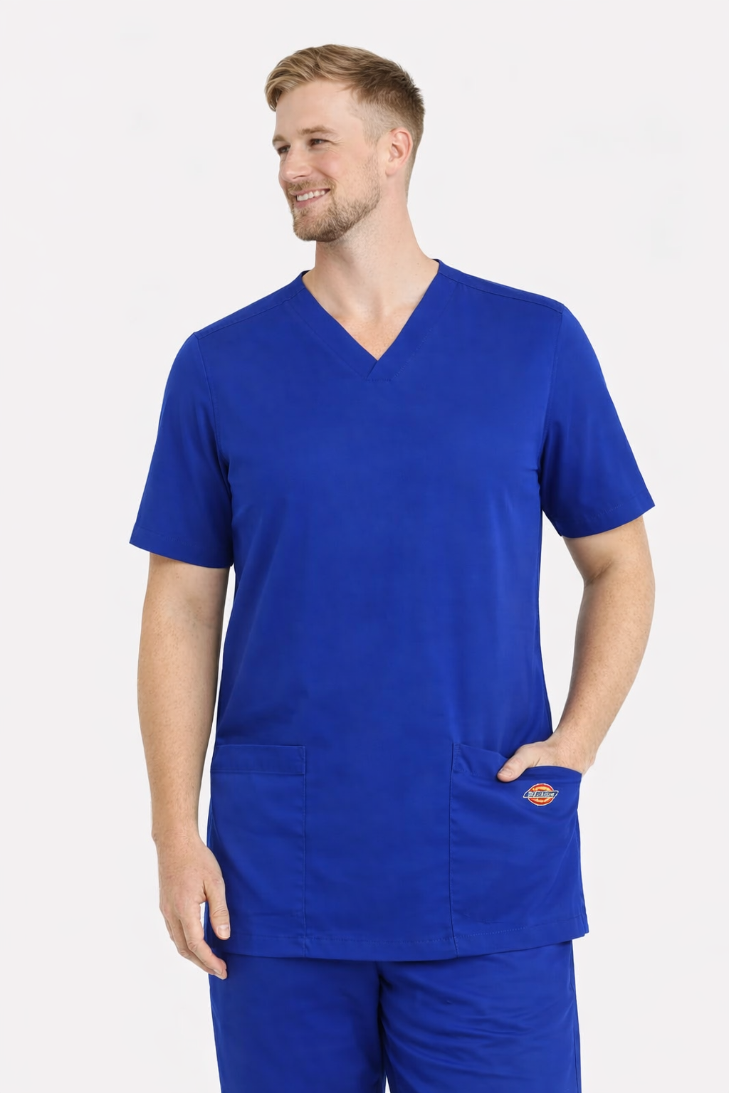 Man wearing a blue scrub set with a Dickies logo on a white background