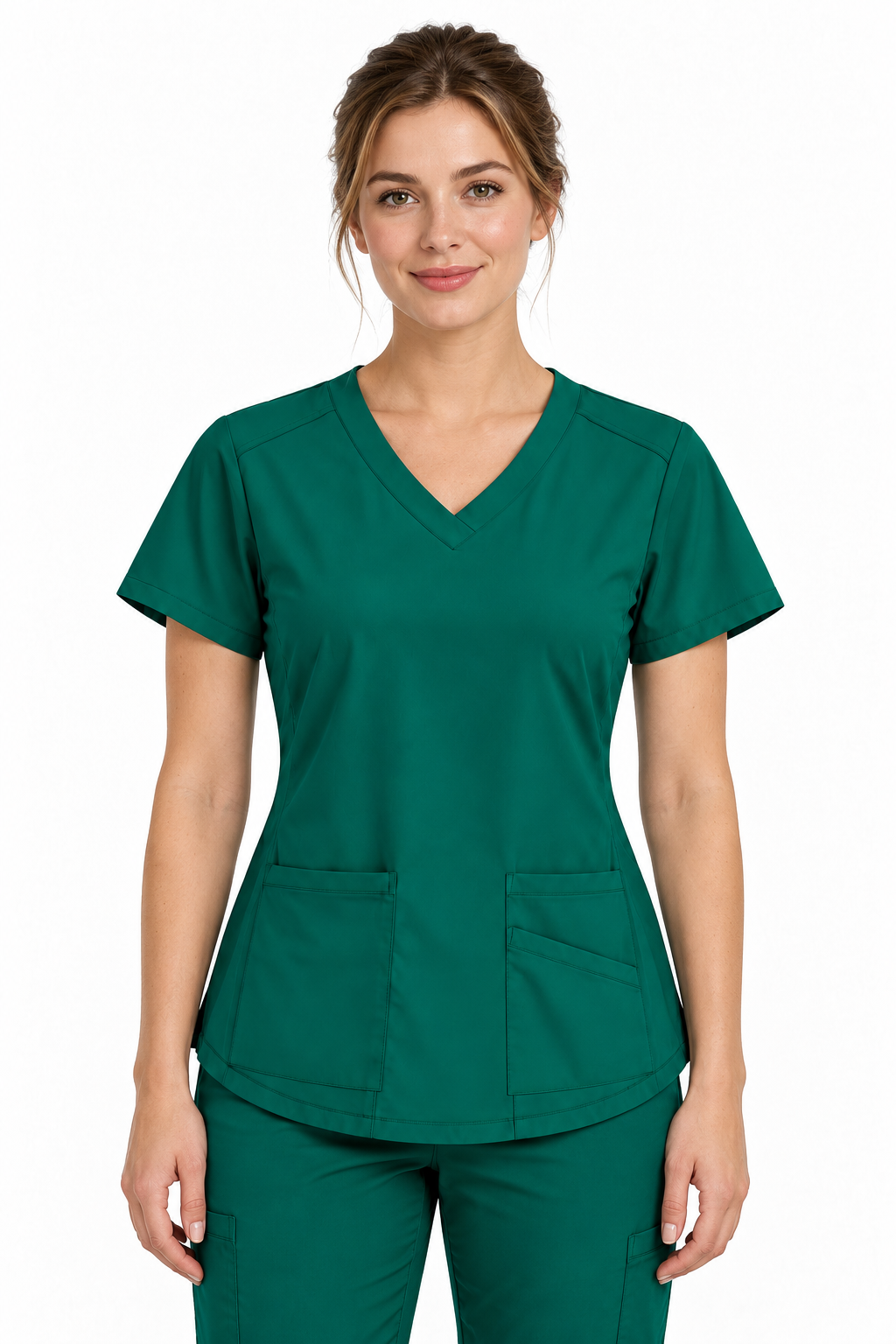A woman modeling a dark green V-neck scrub top and matching scrub pants against a plain white background.