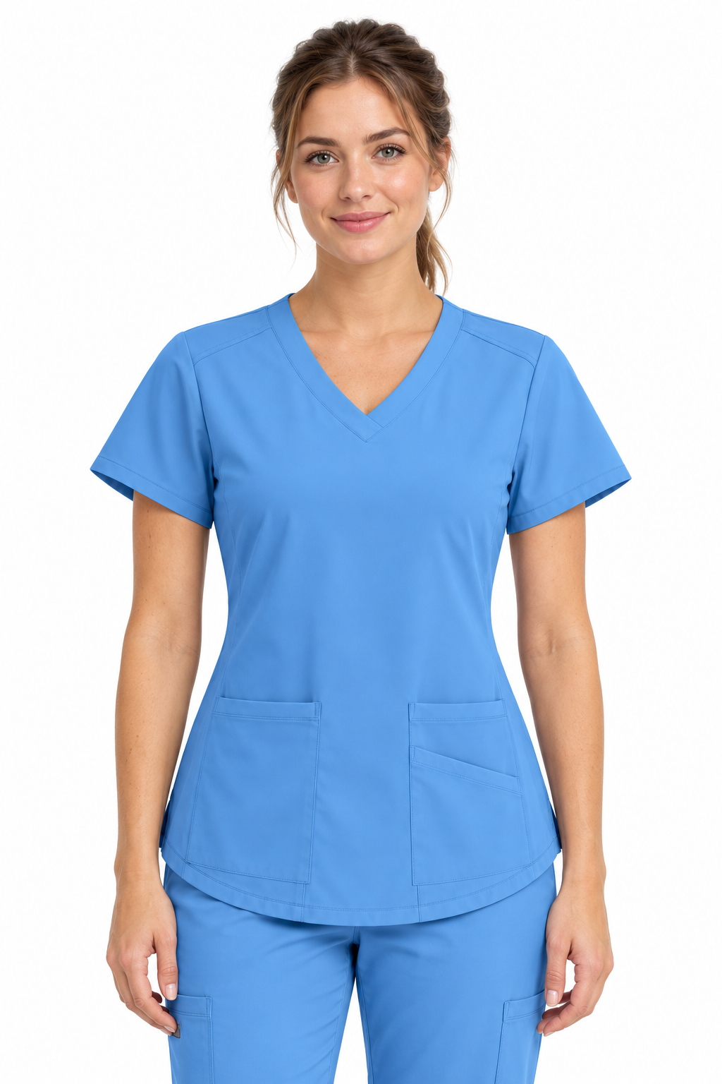 A woman modeling a bright blue V-neck scrub top and matching scrub pants against a plain white background.